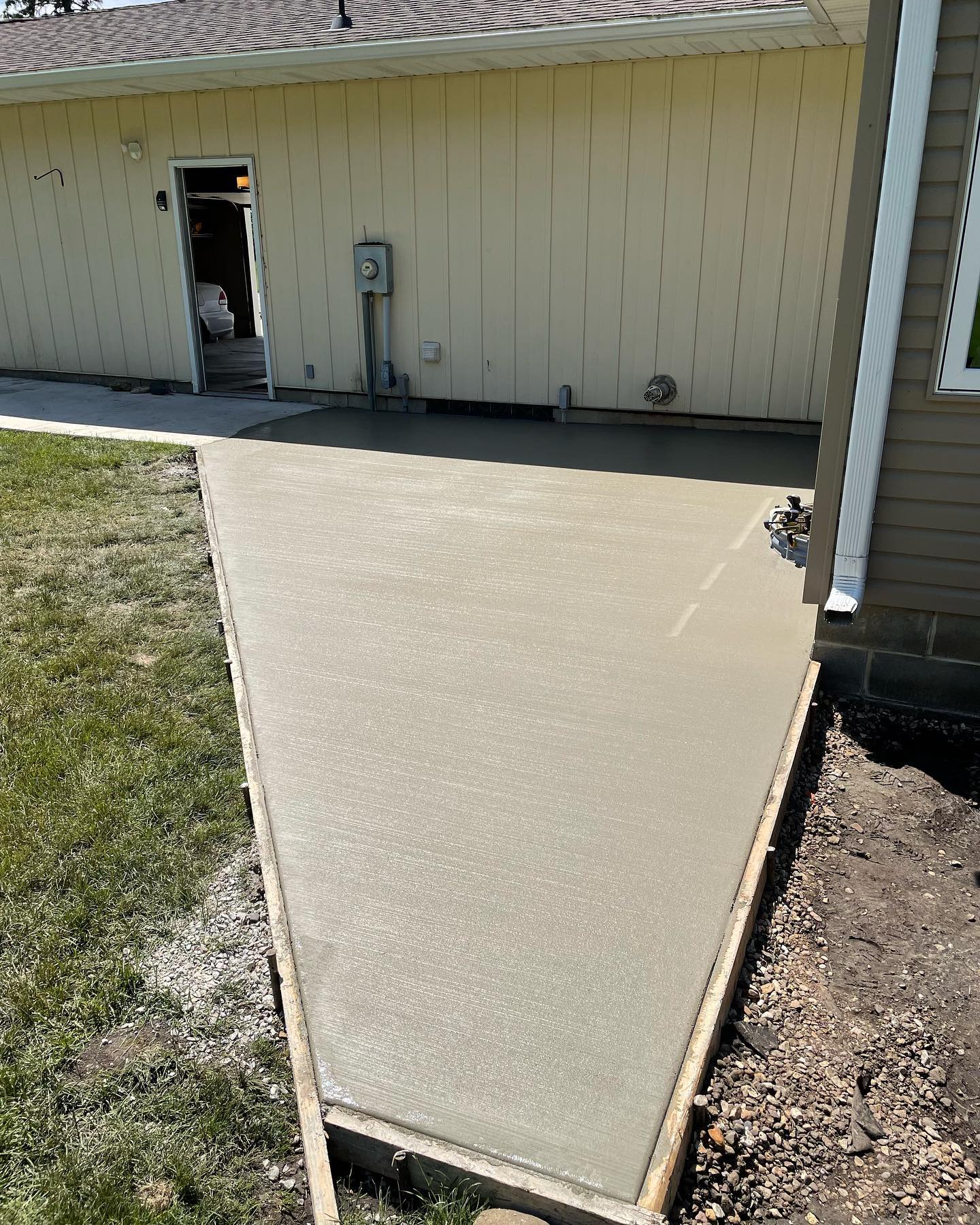 New concrete patio behind a home