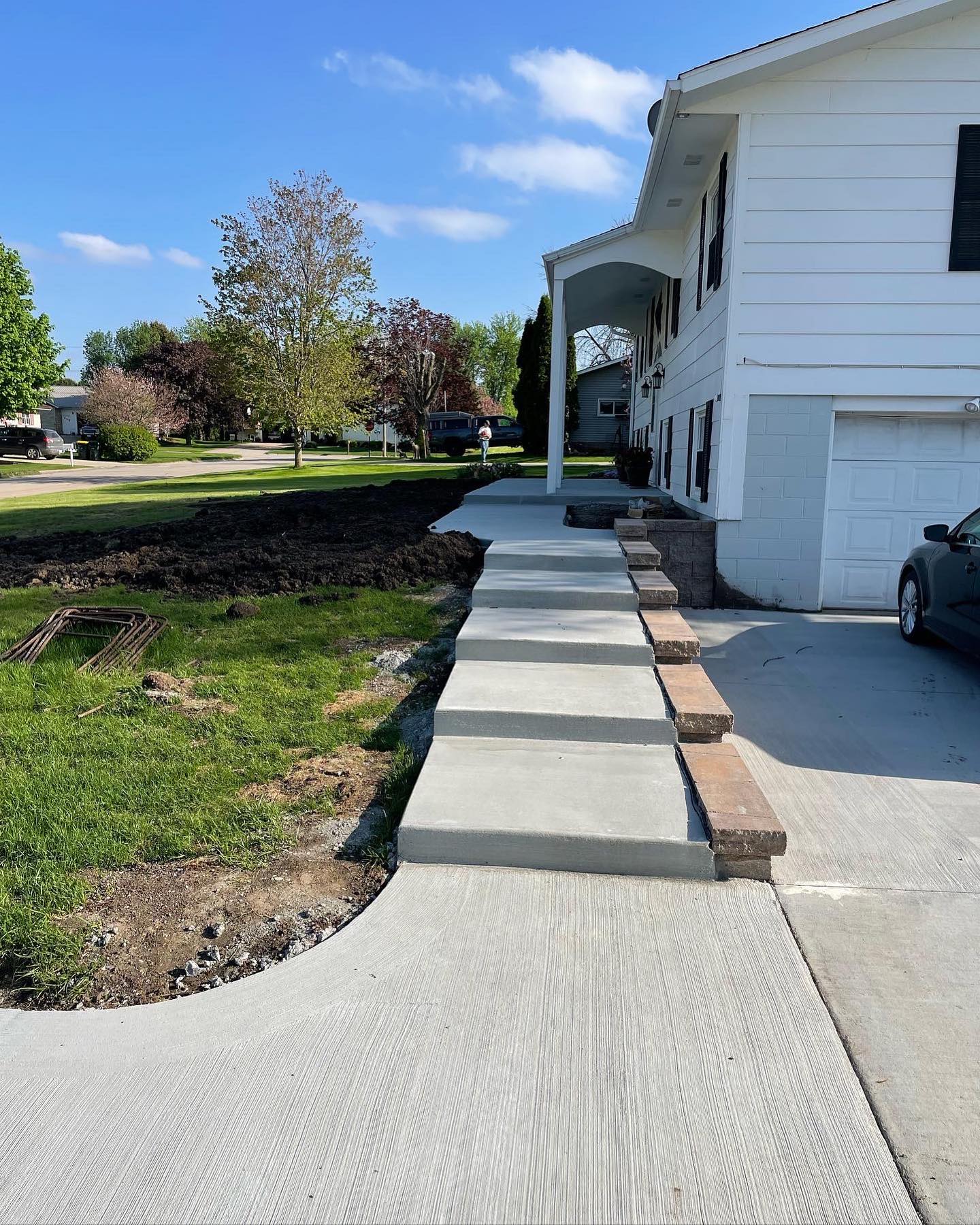 Stepped concrete walkway beside a split-level home