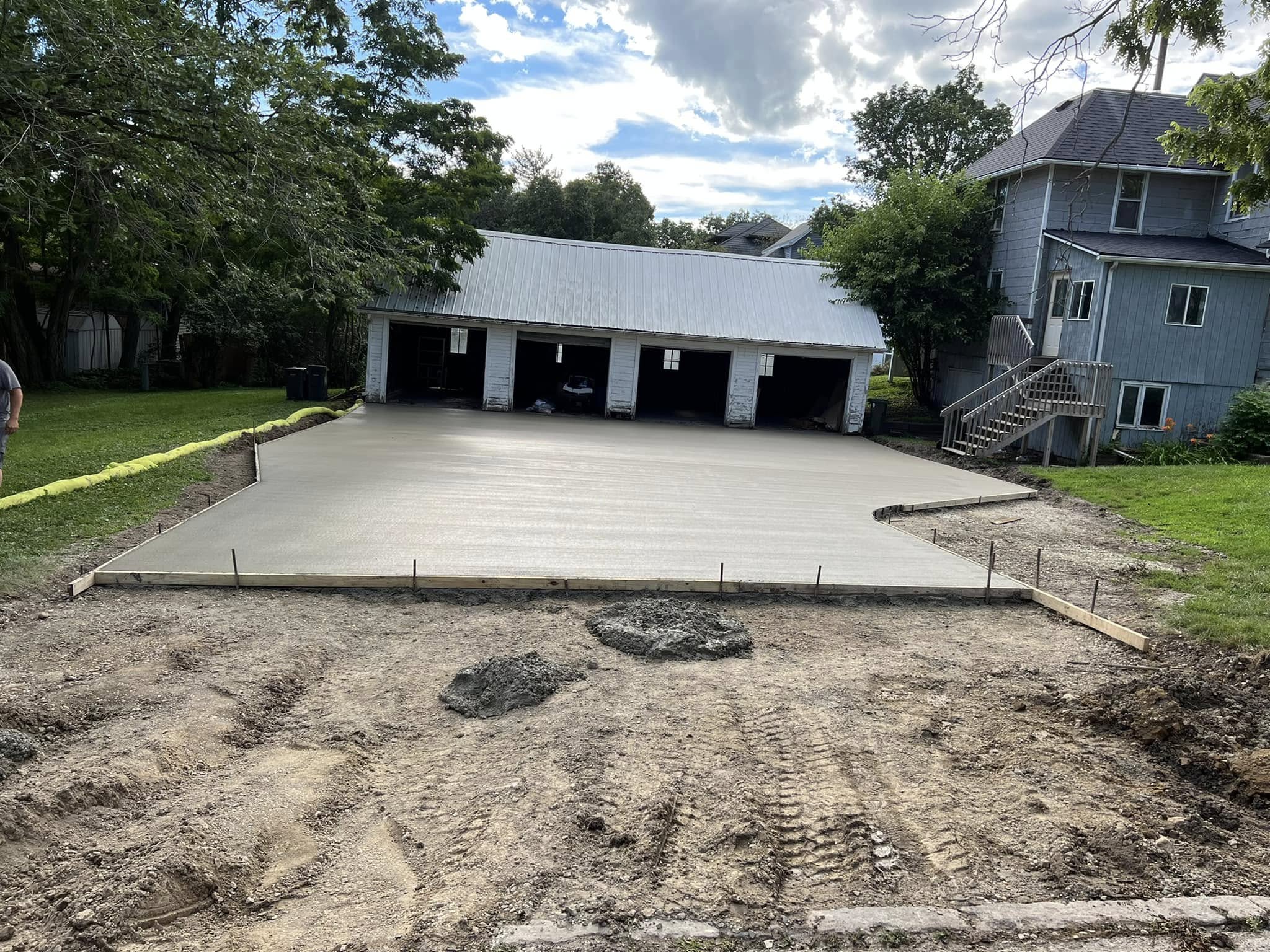 Large concrete slab in front of a multi-bay garage