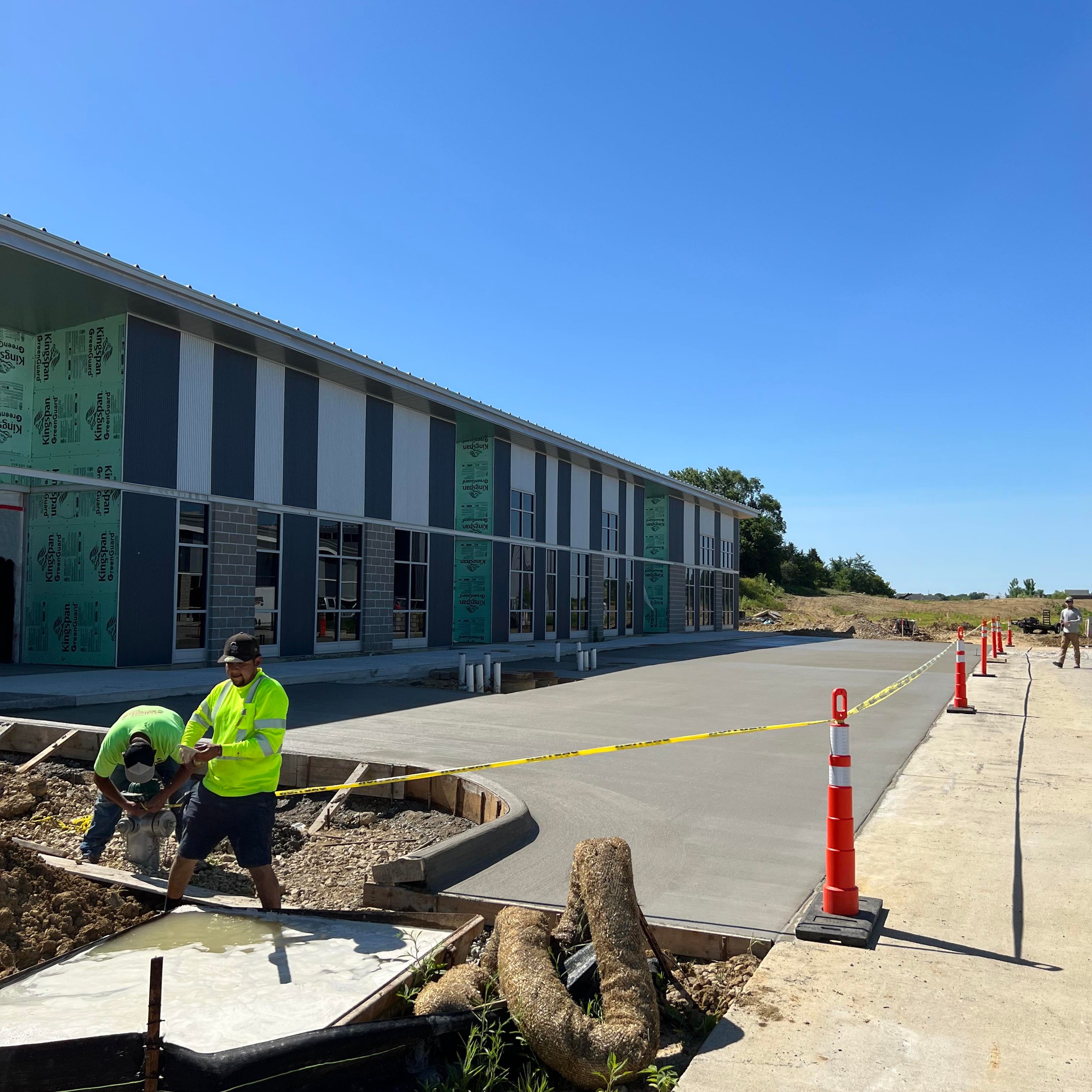 Fresh concrete sidewalk and approach alongside a commercial building
