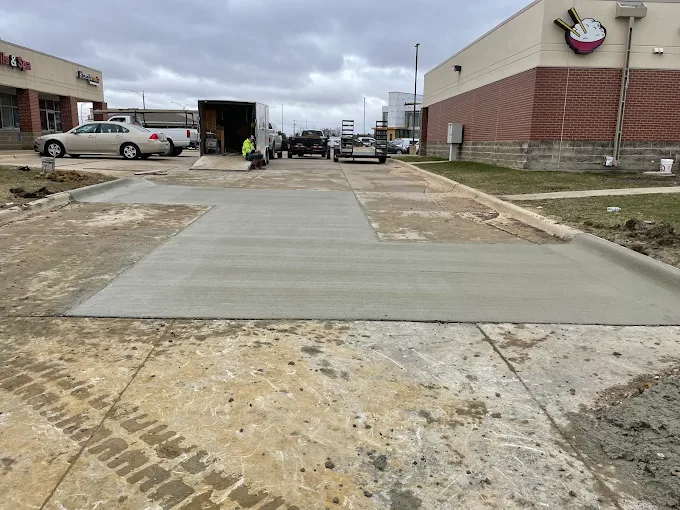 Fresh commercial concrete drive entrance between retail buildings